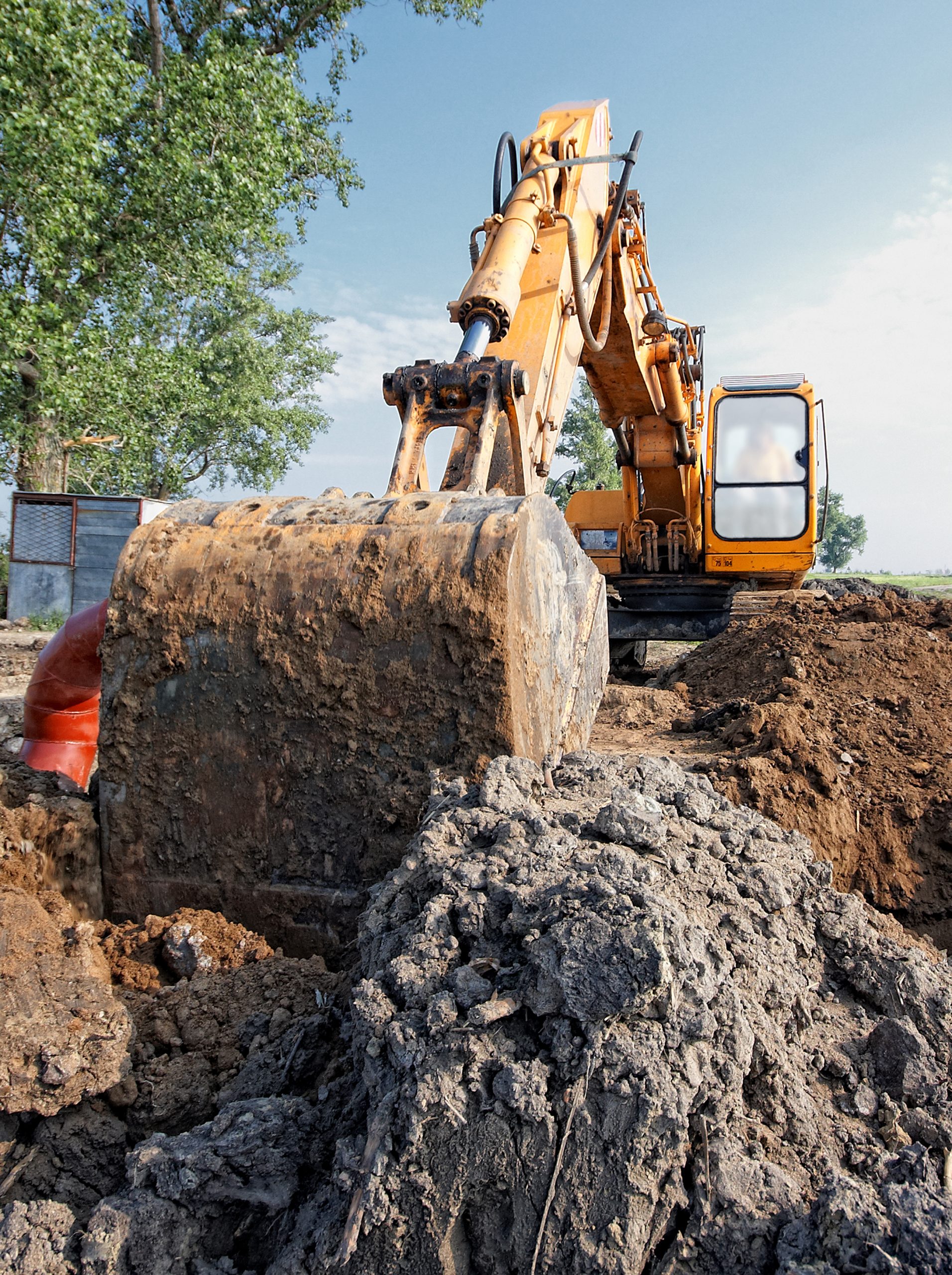 excavator digs a hole