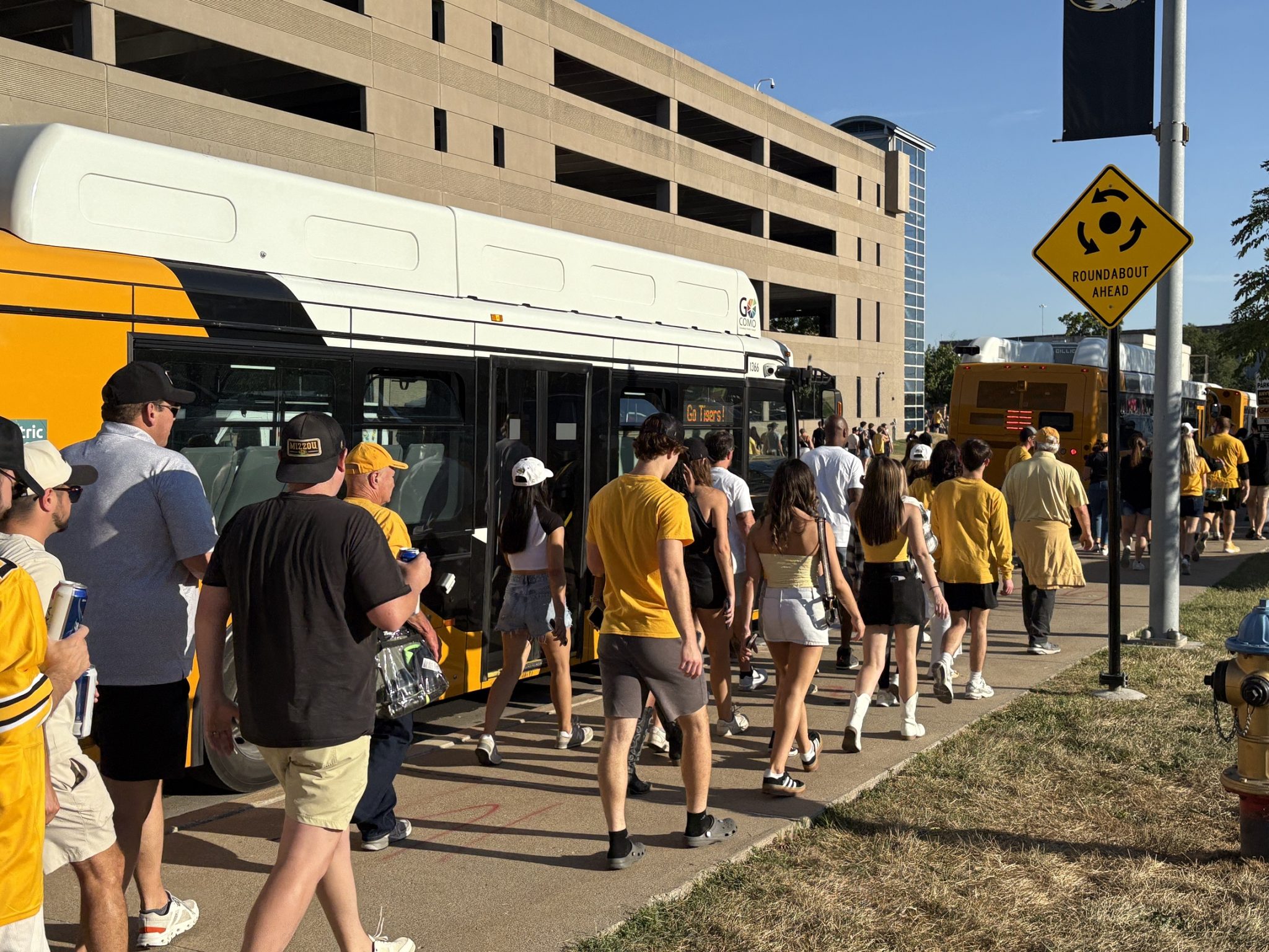 fans walk along go como buses parked near the tiger ave and hospital dr roundabout aug. 28 2025 (002)